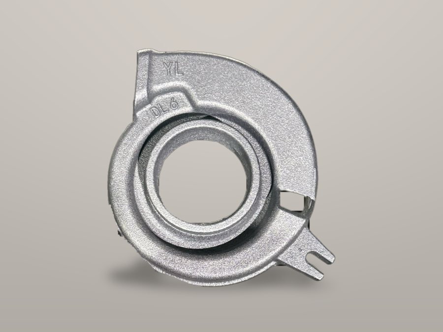 Spiral volute pump casing on a workbench-grey background