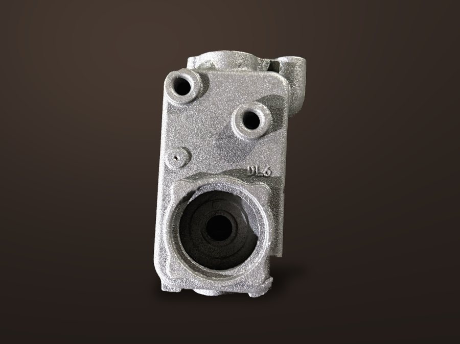 Square sand-cast pump casing on a dark studio background