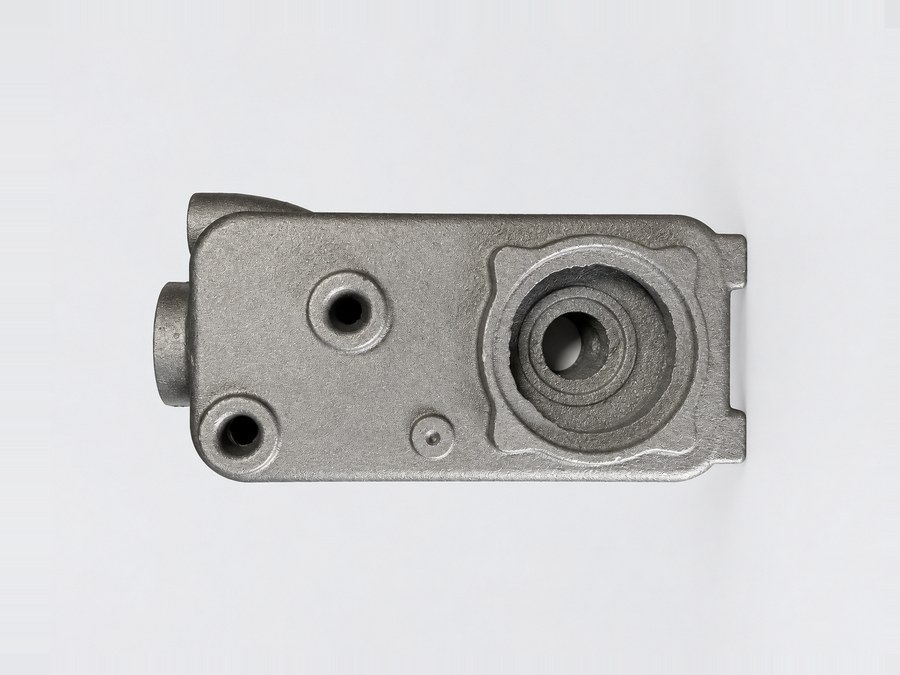Sand-cast pump casing with threaded bores and a stepped impeller chamber