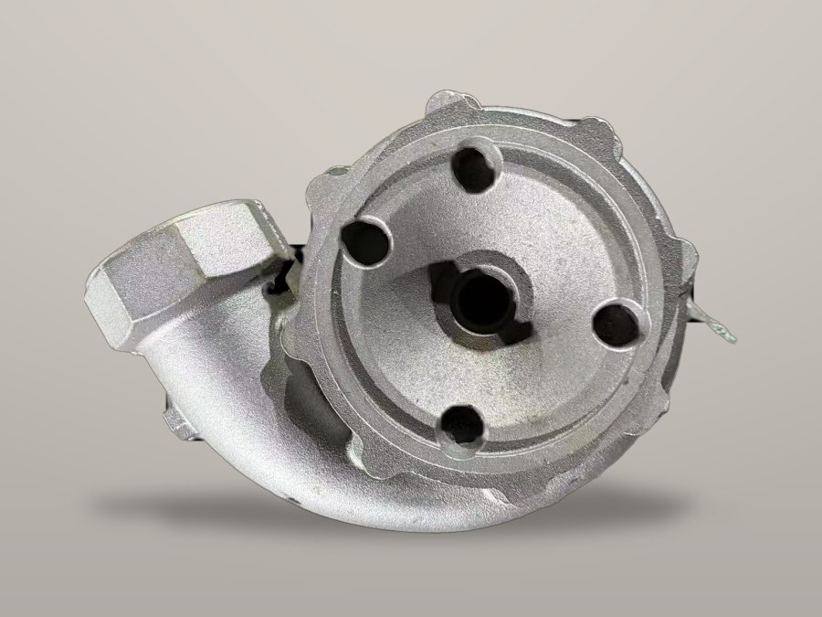 Cast pump cover with machined register, workbench-grey background