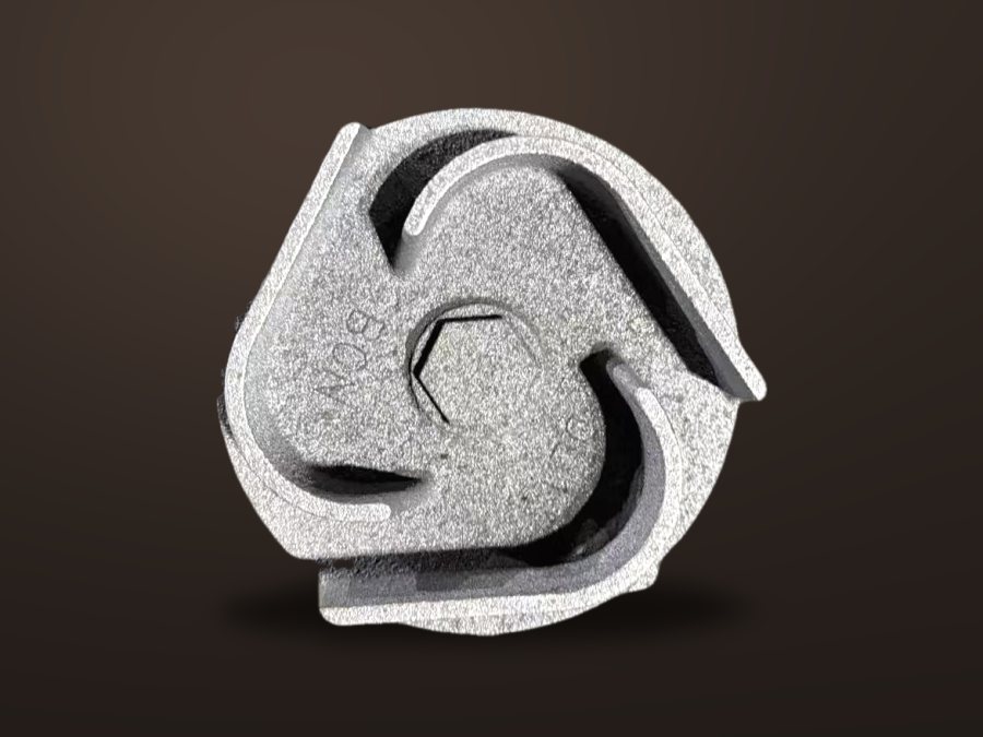 Semi-open cast iron impeller on a dark studio background