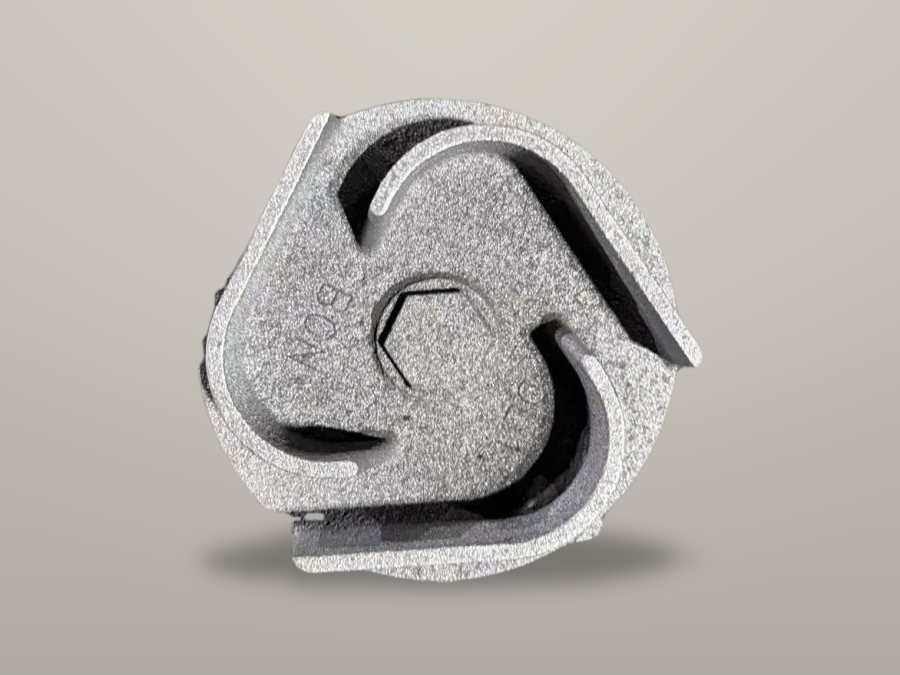 Semi-open cast iron impeller on a workbench-grey background